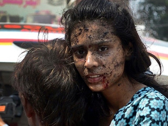 Peshawar Carnage victim looks on in shock and disbelief after the blast at church.