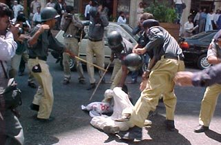 Sindh Police beating a protester in Karachi